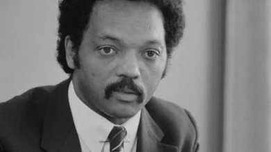 Jesse Jackson half length portrait of Jackson seated at a table July 1 1983 edit.jpg e1771330535962